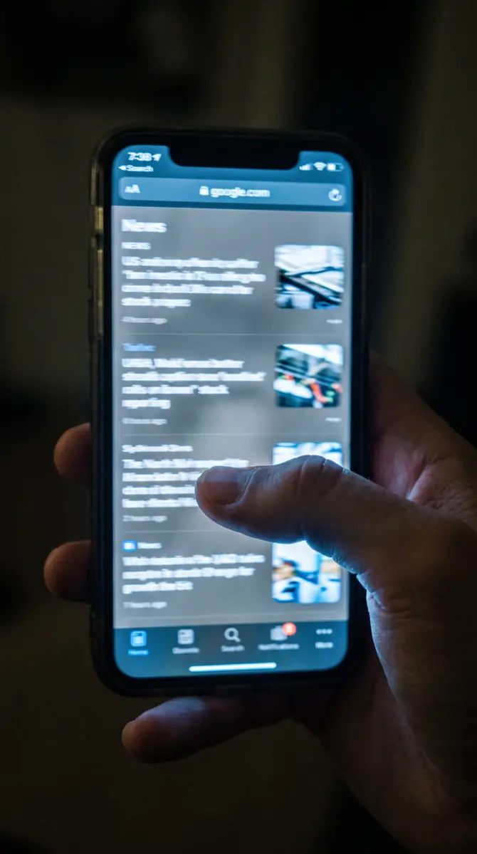 Point-of-view shot of a thumb endlessly scrolling a phone feed.