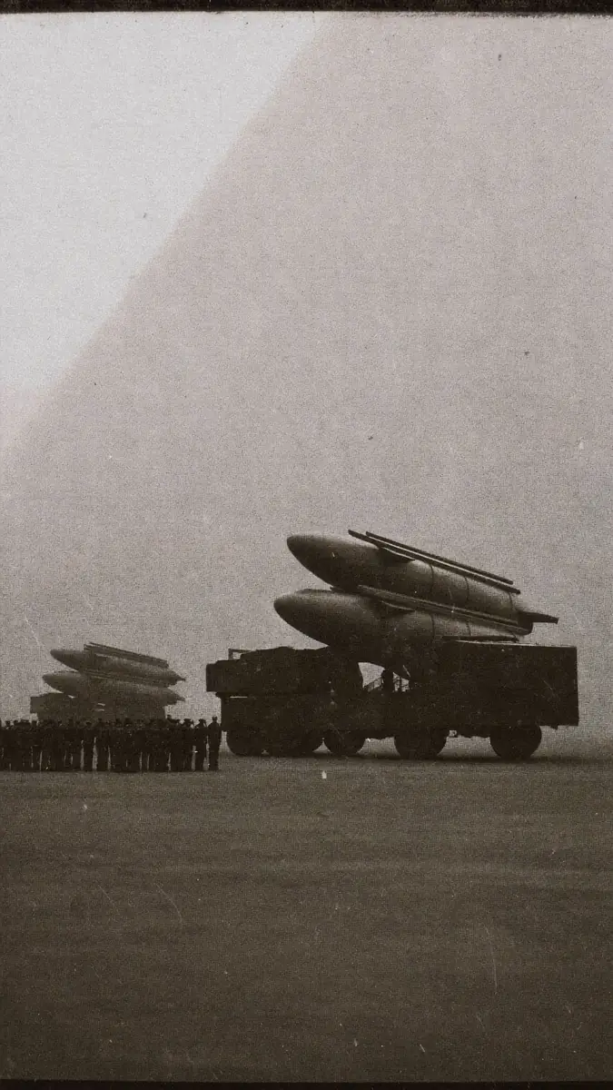 Archival newsreel still of a missile parade.